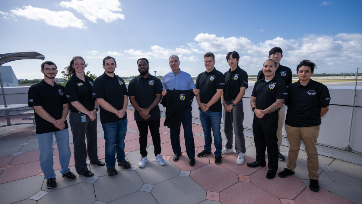 Jeff Knittel posing for a photo with Embry-Riddle's SAT Club (Society of Aerospace Technicians)