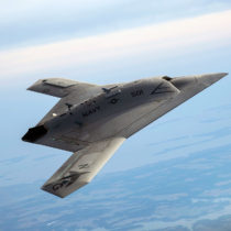 A Northrop Grumman designed aircraft soars through the sky.