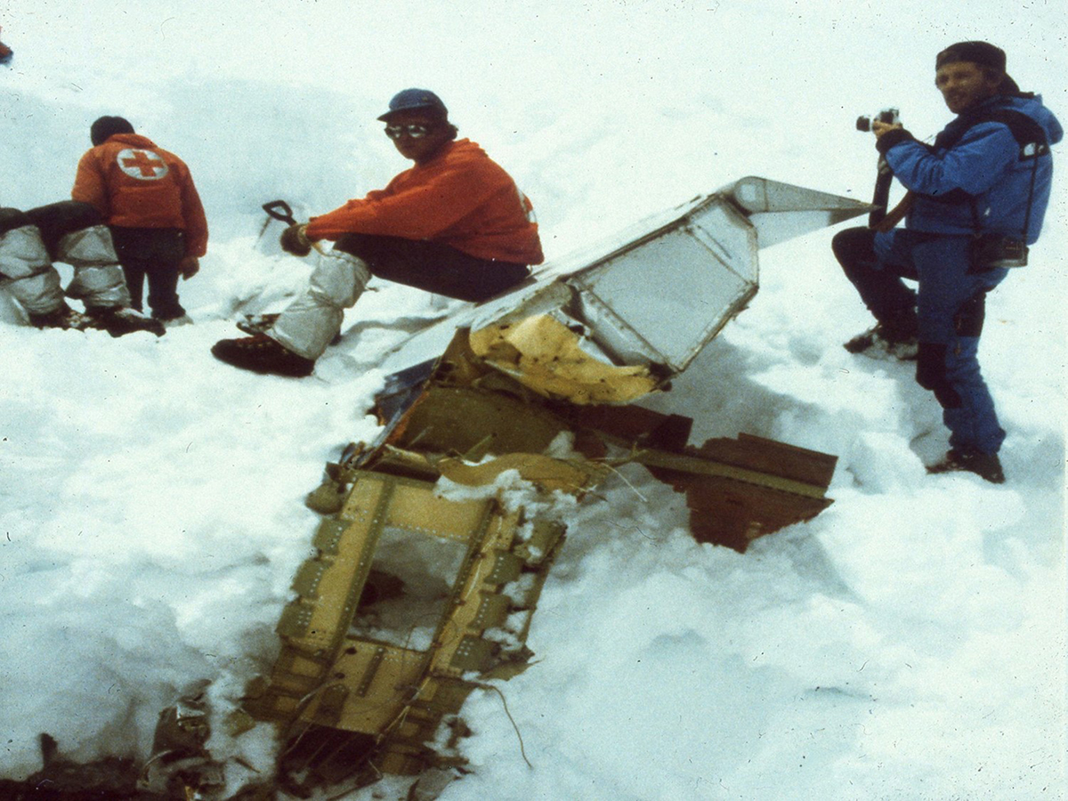 Greg Feith, far right, photographs aircraft wreckage from the 1985 Eastern Airlines Flight 980 crash atop Mount Illimani in Bolivia.