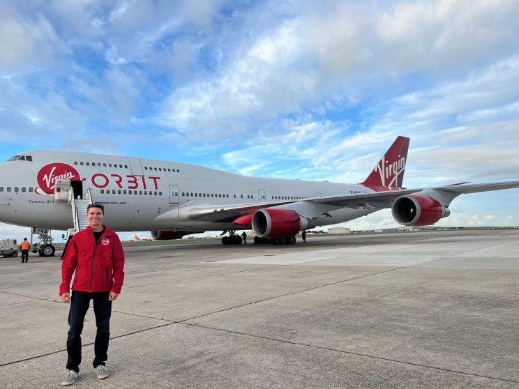 Test pilot Eric Bippert stands in front of Virgin Orbit's Cosmic Girl 747 jet.