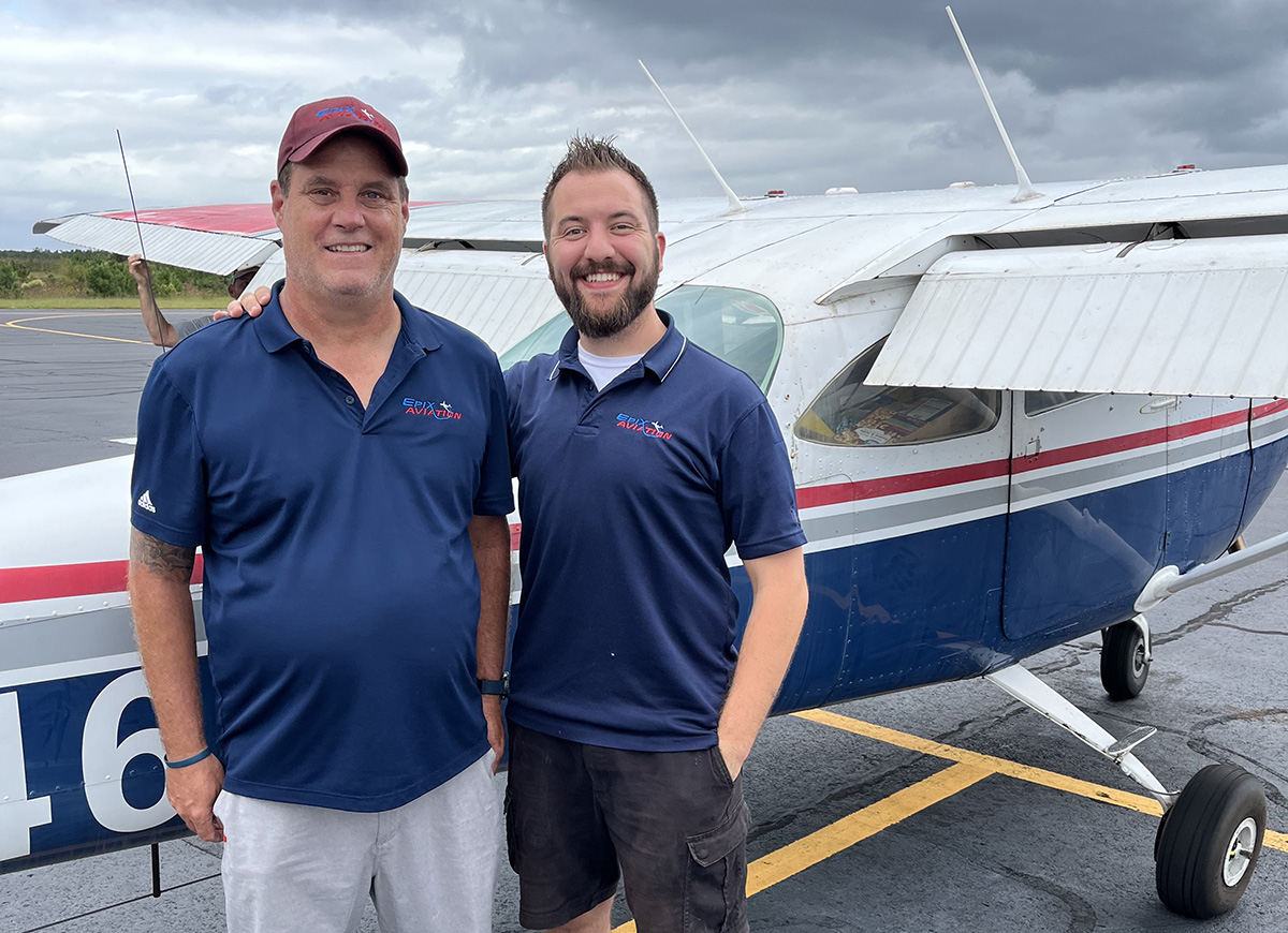 Chris Desjarlais and Mark Hubbert stand in front of Cessna airplane