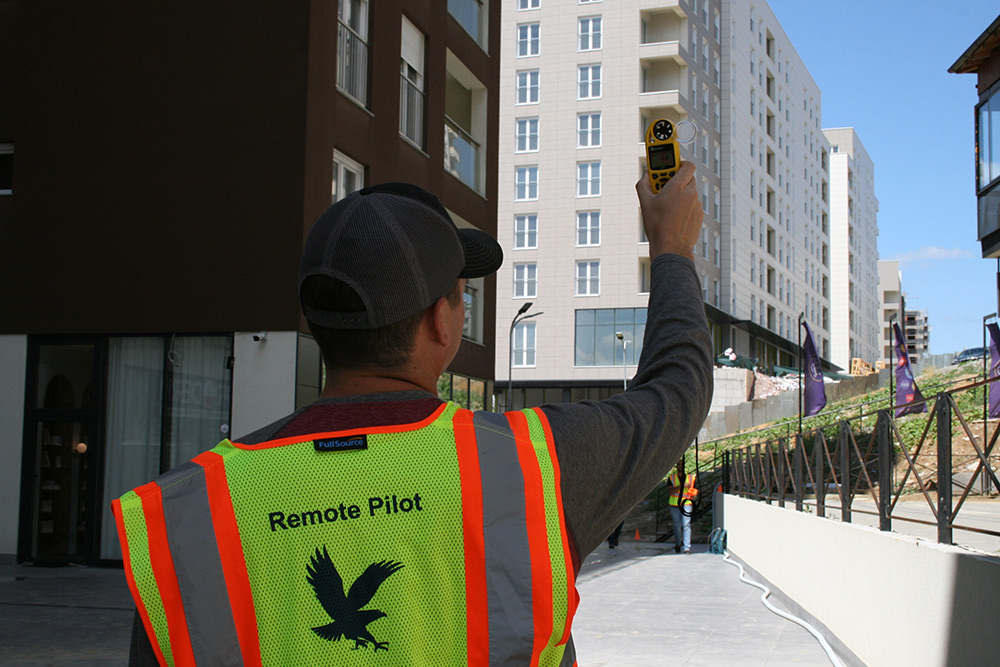 Remote pilot operating a meteorological drone in urban Kosovo