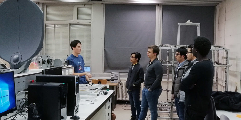 Student providing a tour of a university lab in Luxembourg