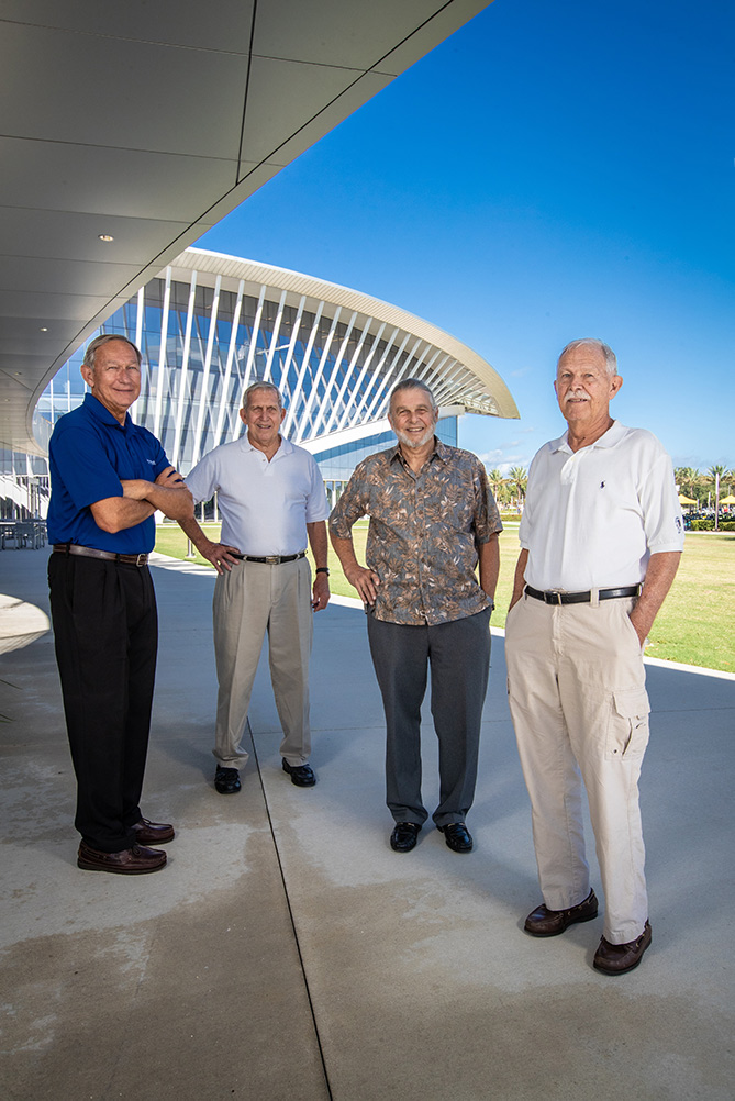 Four brothers standing at the ERAU campus, student union in the background