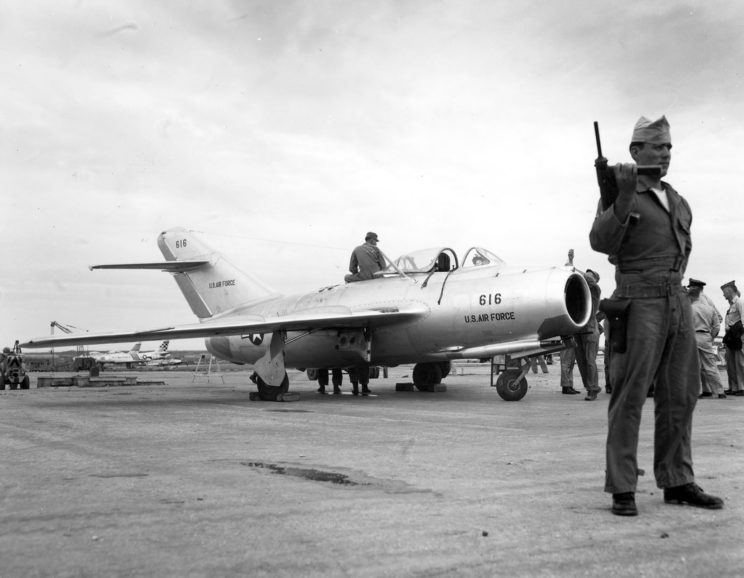 Under constant guard by Air Police at a U.S. Air Force installation on Okinawa, reassembly of the MIG-15 is completed on the flight line. After careful ground testing, the Russian-built fighter was flown by five U.S. Air Force pilots during a week of extensive tests. October 1953. U.S. Air Force Photo