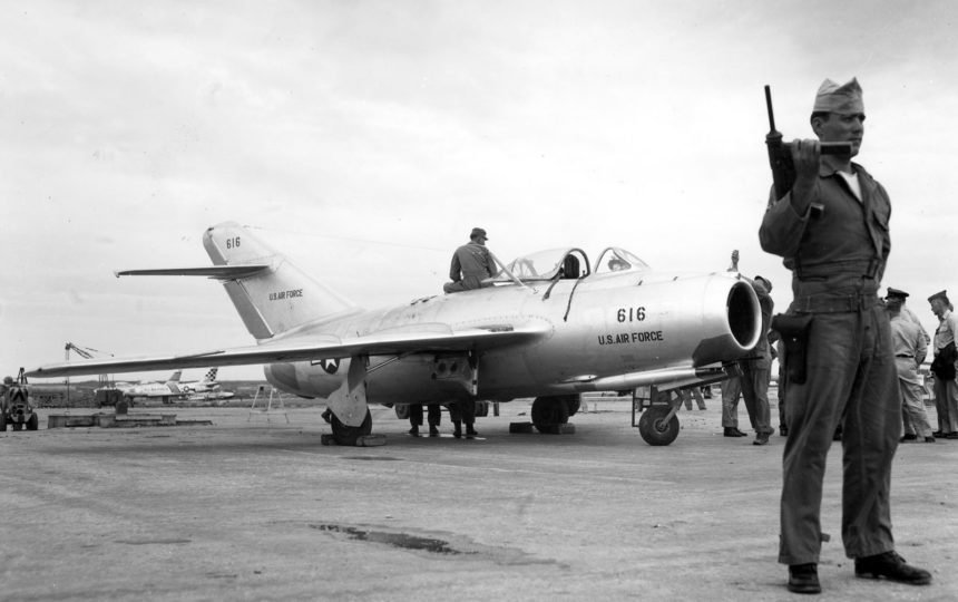 Under constant guard by Air Police at a U.S. Air Force installation on Okinawa, reassembly of the MIG-15 is completed on the flight line. After careful ground testing, the Russian-built fighter was flown by five U.S. Air Force pilots during a week of extensive tests. October 1953. U.S. Air Force Photo