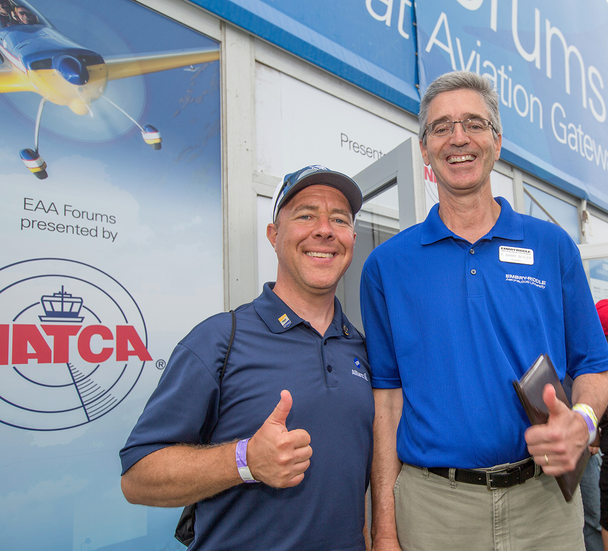 Dr. P. Barry Butler stands for a picture with an alum during the Embry-Riddle Alumni BBQ on day three of EAA Airventure in Oshkosh, WI, July 26, 2017. (Embry-Riddle/David Massey)
