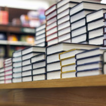 Stacks of books on a table in a library or bookstore