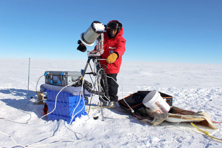 Michael Nayak setting up telescope in Antarctica.