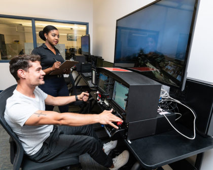 Two students using a computer simulator