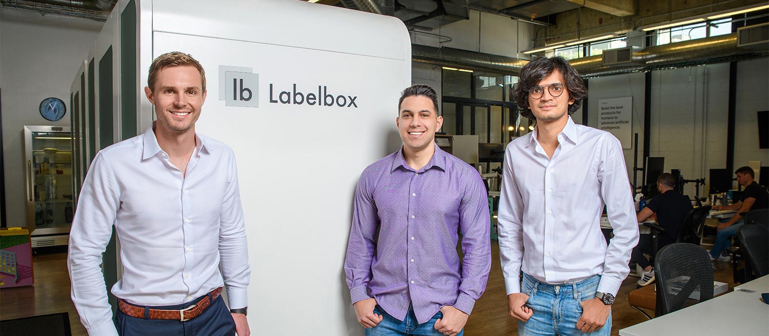Three alumni standing together at their startup company Labelbox