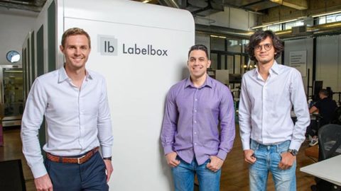 Three alumni standing together at their startup company Labelbox