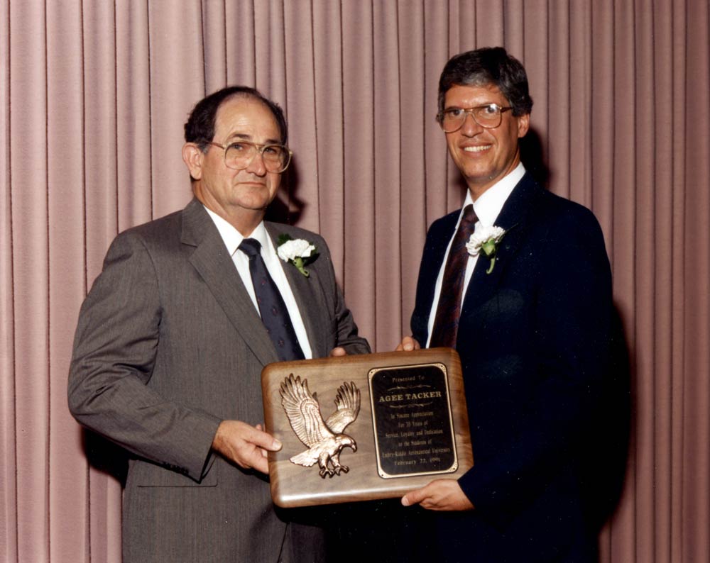 AC Tacker, left, receiving an award.