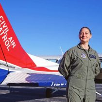 Woman in uniform next to a Civil Air Patrol airplane