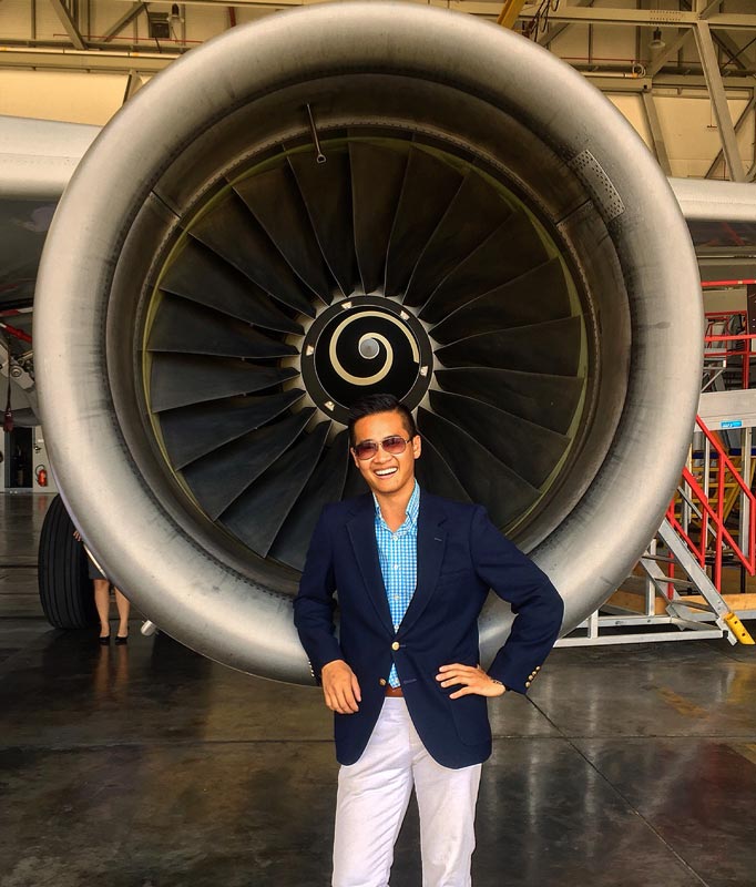 Alex Damon standing in front of a jet engine.