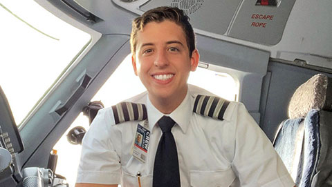 Sergio Sovero ('16) in a pilot's uniform, seated the right seat of an airplane flight deck
