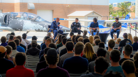 Jared Isaacman speaks with students and faculty at a hangar