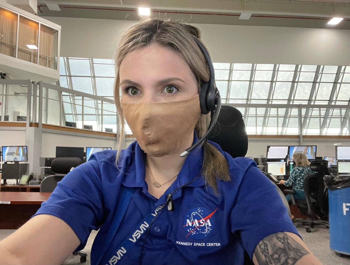 Alora Mazarakis in control center at NASA while wearing face mask.