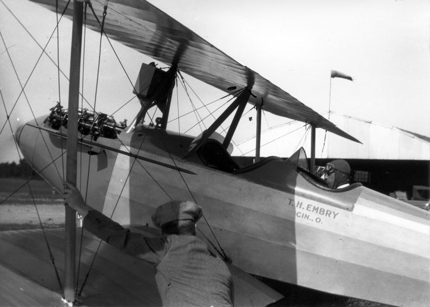 T. Higbee Embry seated in a biplane at Lunken Field.