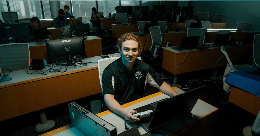 Ryan Ferguson sits at desk with laptop