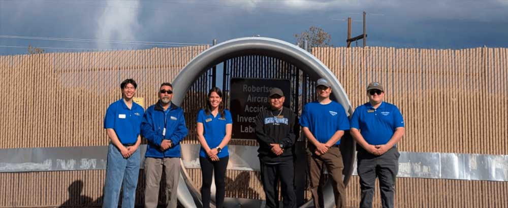 Tiffany Terry and 5 fellow students stand at the Robertson Aircraft Investigation Lab