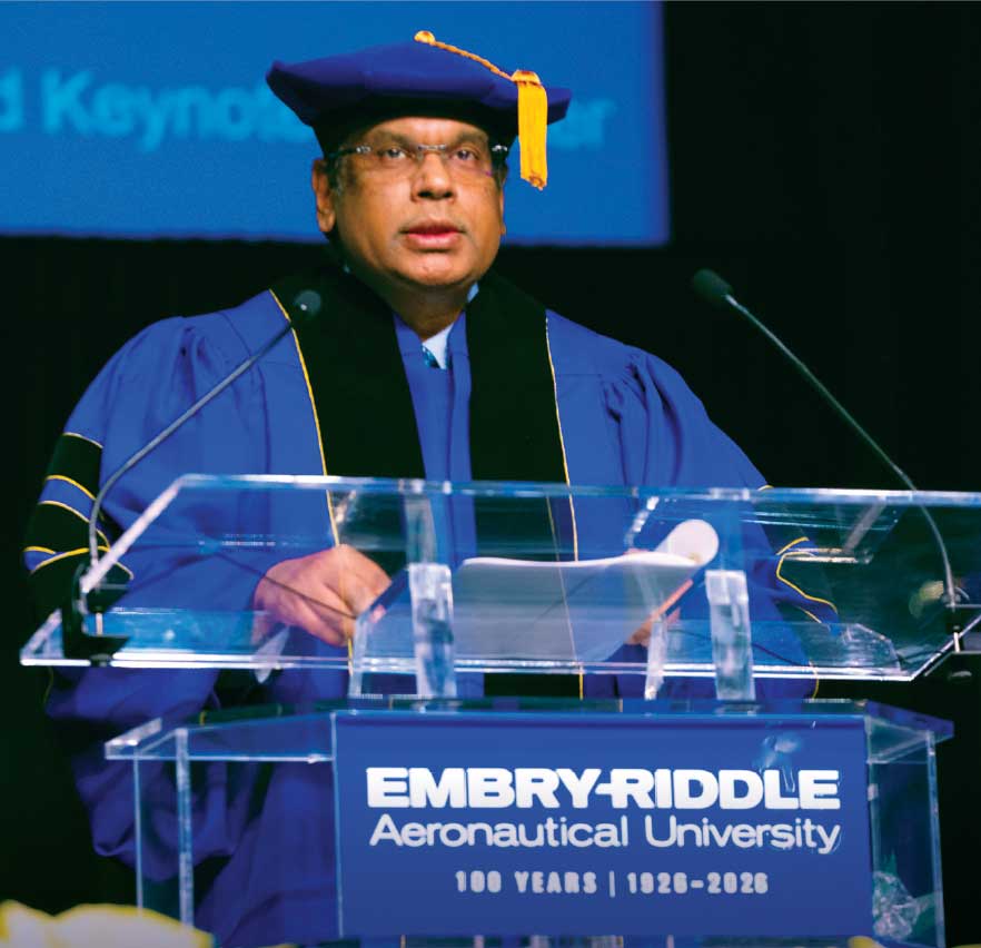 Vivek Lall stands at podium