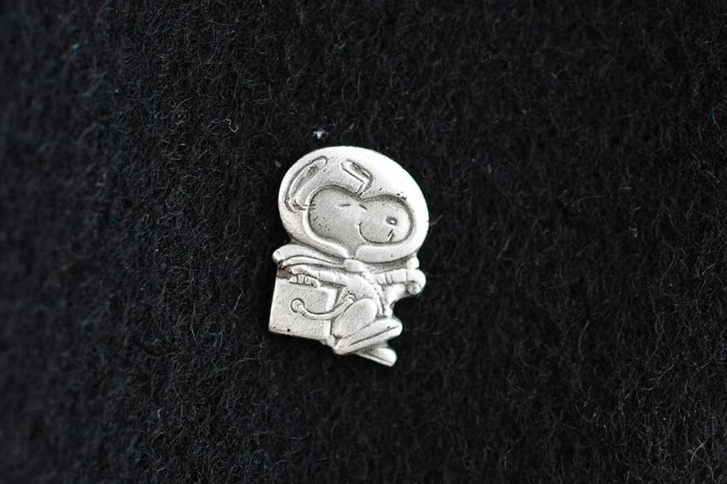 Silver Snoopy award pin with a Snoopy in a space suit.