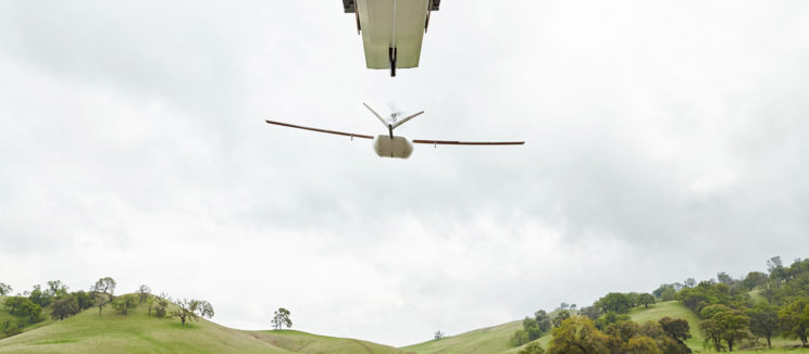 Zipline drone taking off from launcher over rural Rwanda