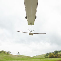 Zipline drone taking off from launcher over rural Rwanda